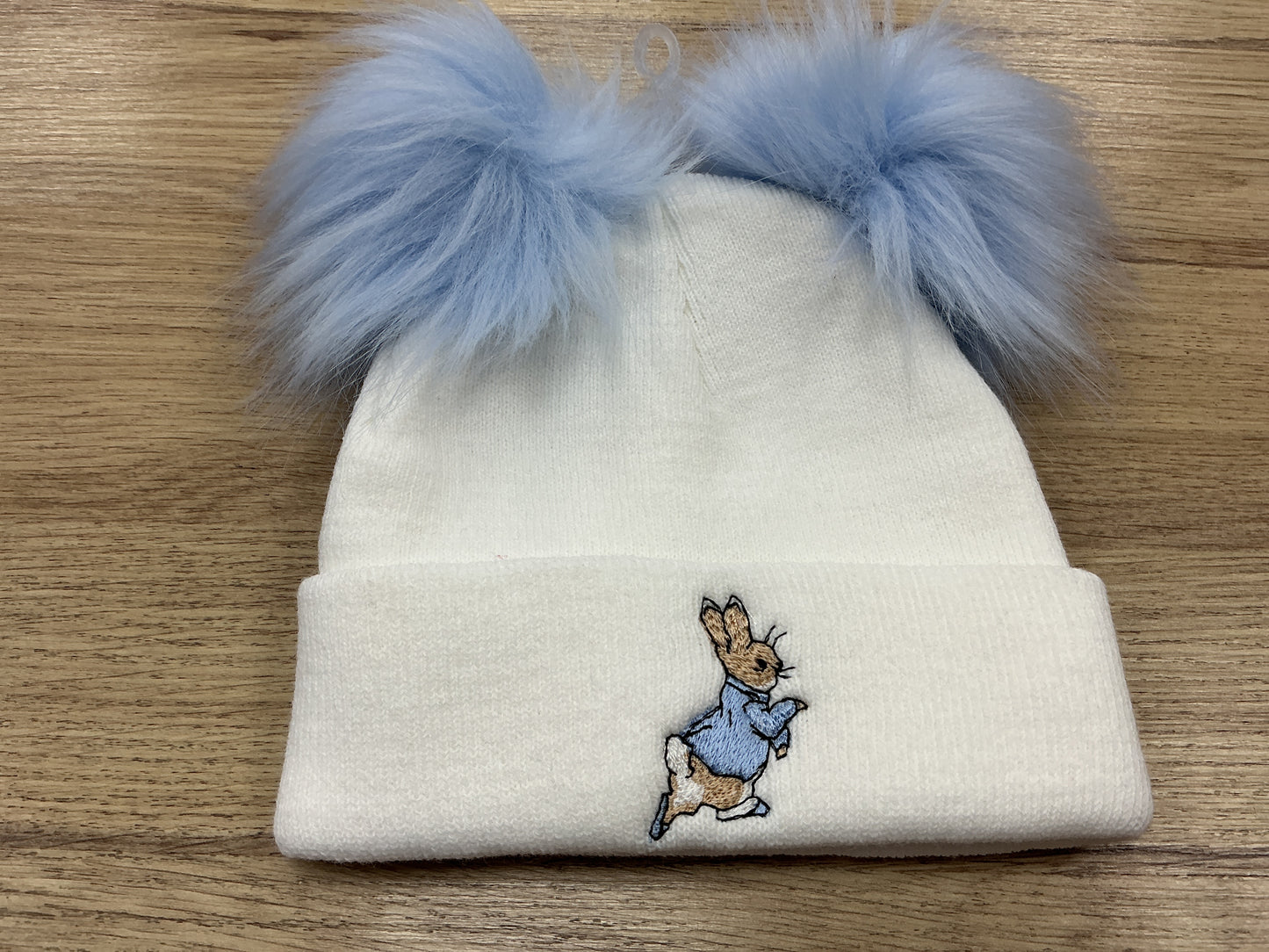 Large blue embroidered Peter rabbit white hat with pink faux Pom poms and turnover