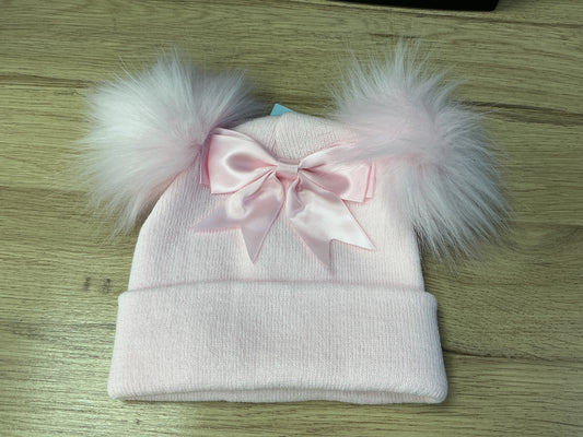Pink ribbed hat with pink faux pom Poms ,large bow and turnover