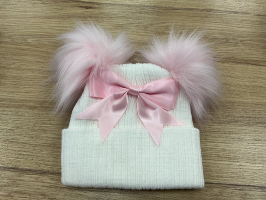 White ribbed hat with pink faux pom Poms ,large bow and turnover