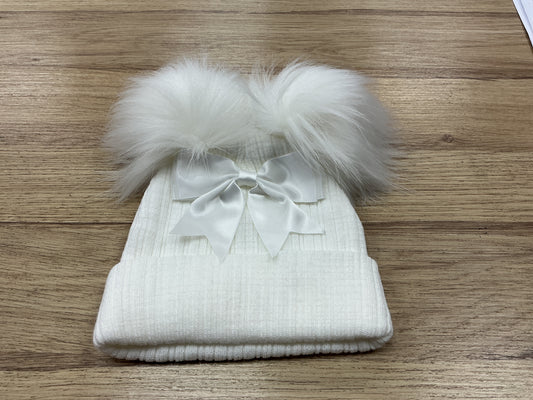 White ribbed hat with white faux pom Poms ,large bow and turnover
