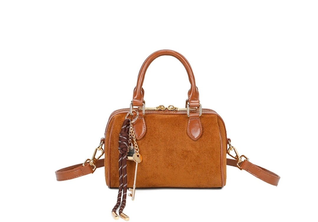 Small Suede Handbag with Clasp Lock and Charms Attached . Long Crossbody Strap