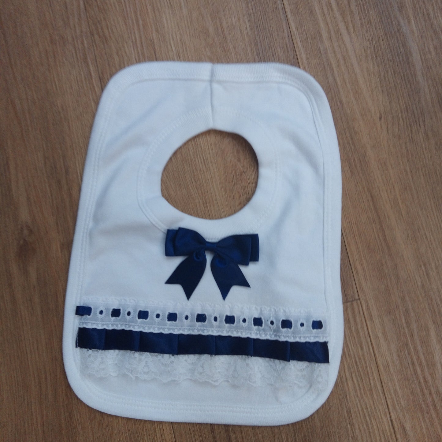 Navy Trim Pull Over Bib with Bow